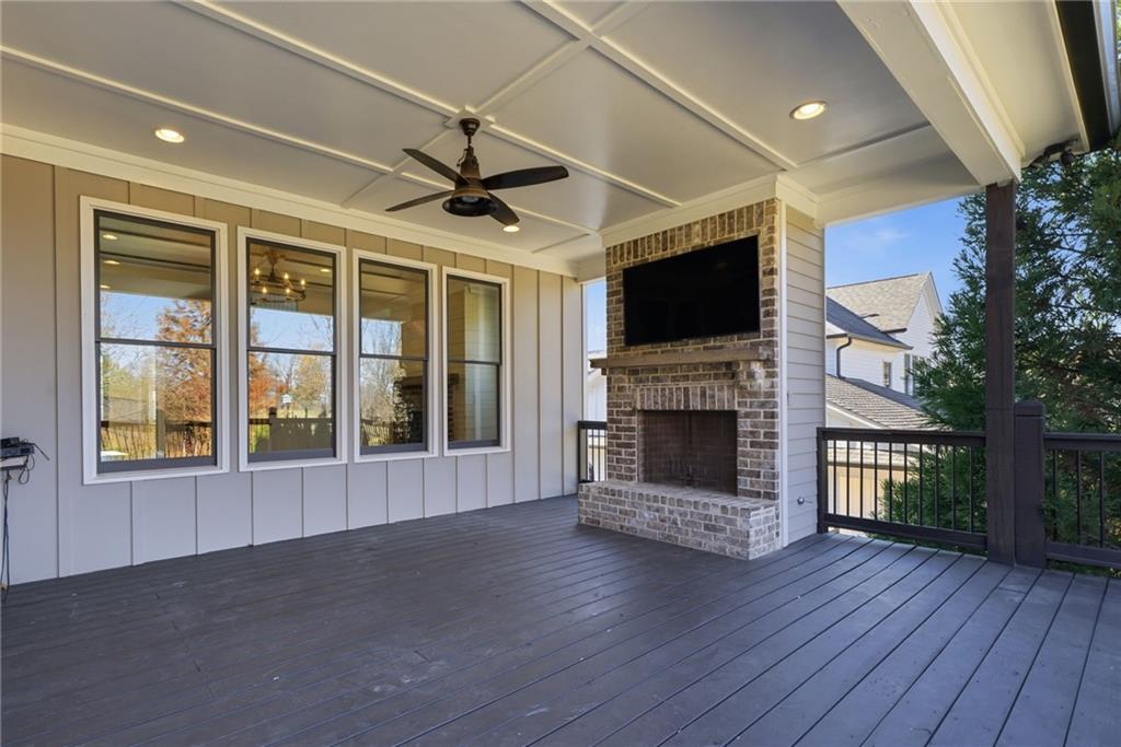 2755 Rustic Lk Terrace Cumming, GA 30041 - Photo 40 of 141 a view of an empty room with wooden floor fireplace and a window