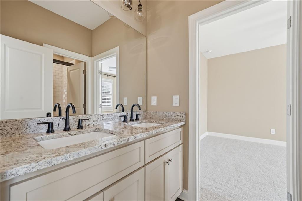 2755 Rustic Lk Terrace Cumming, GA 30041 - Photo 45 of 141 a bathroom with a sink and a mirror