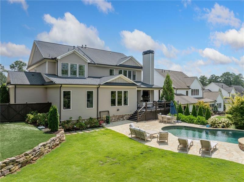 2755 Rustic Lk Terrace Cumming, GA 30041 - Photo 5 of 141 a front view of a house with a yard table and chairs