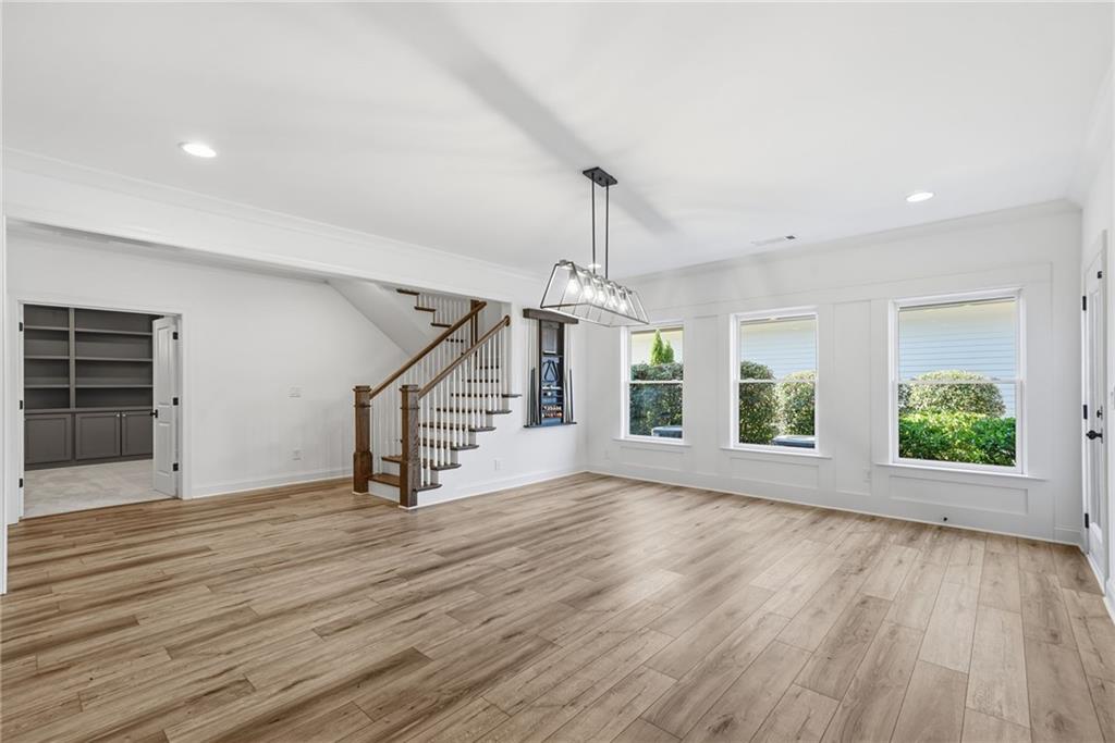 2755 Rustic Lk Terrace Cumming, GA 30041 - Photo 60 of 141 an empty room with wooden floor staircase and windows