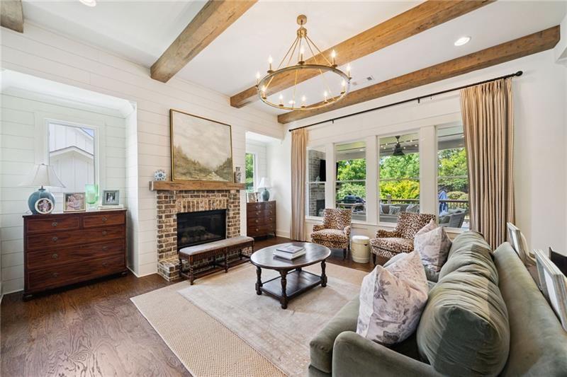 2755 Rustic Lk Terrace Cumming, GA 30041 - Photo 82 of 141 a living room with furniture a fireplace and a large window