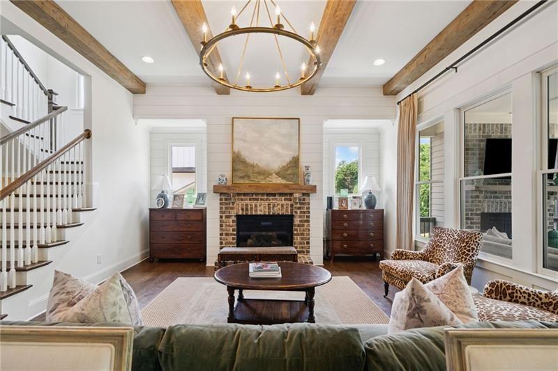 2755 Rustic Lk Terrace Cumming, GA 30041 - Photo 84 of 141 a living room with furniture a fireplace and a chandelier
