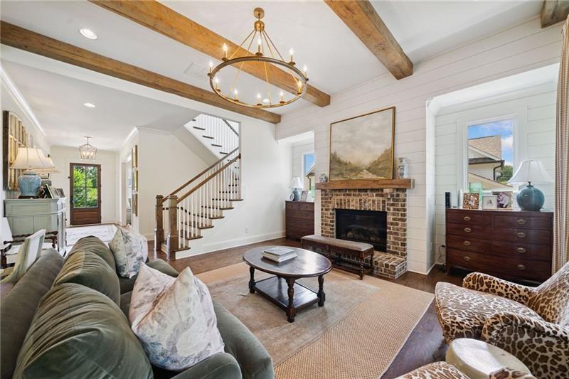 2755 Rustic Lk Terrace Cumming, GA 30041 - Photo 85 of 141 a living room with furniture a fireplace and a chandelier