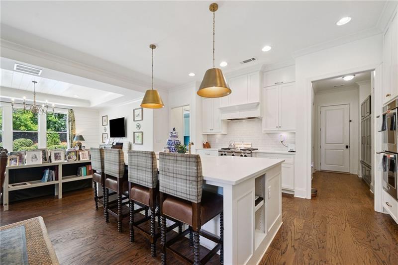 2755 Rustic Lk Terrace Cumming, GA 30041 - Photo 90 of 141 a kitchen with stainless steel appliances granite countertop a stove a refrigerator a oven a sink with a dining table and chairs