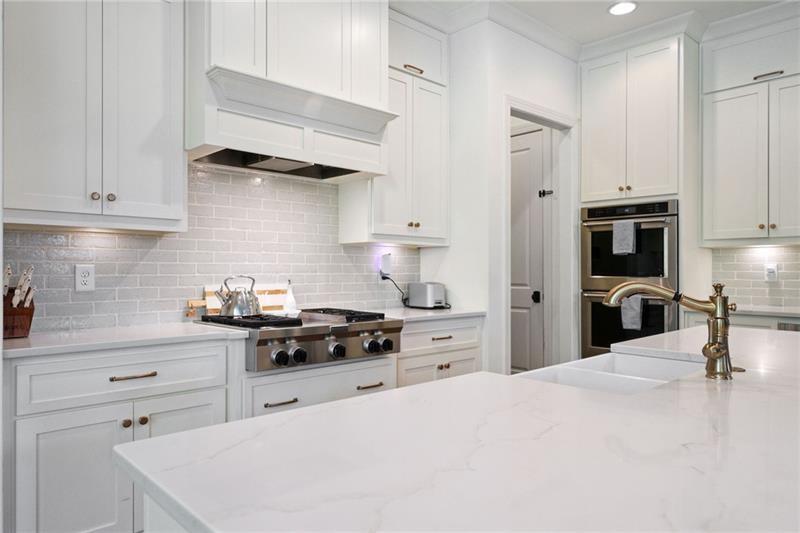 2755 Rustic Lk Terrace Cumming, GA 30041 - Photo 91 of 141 a kitchen with stainless steel appliances a stove a sink and cabinets