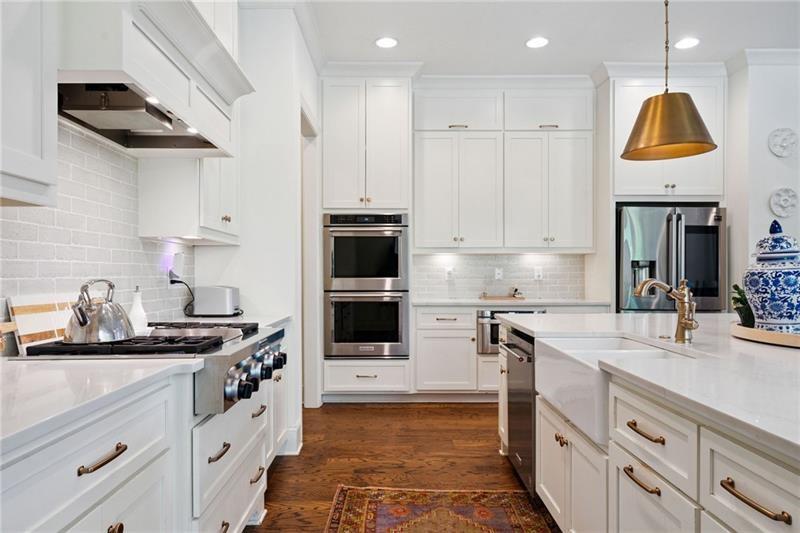 2755 Rustic Lk Terrace Cumming, GA 30041 - Photo 93 of 141 a kitchen with kitchen island granite countertop stainless steel appliances a sink a stove and cabinets