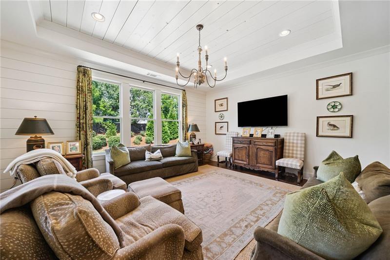 2755 Rustic Lk Terrace Cumming, GA 30041 - Photo 97 of 141 a living room with furniture a flat screen tv and a large window