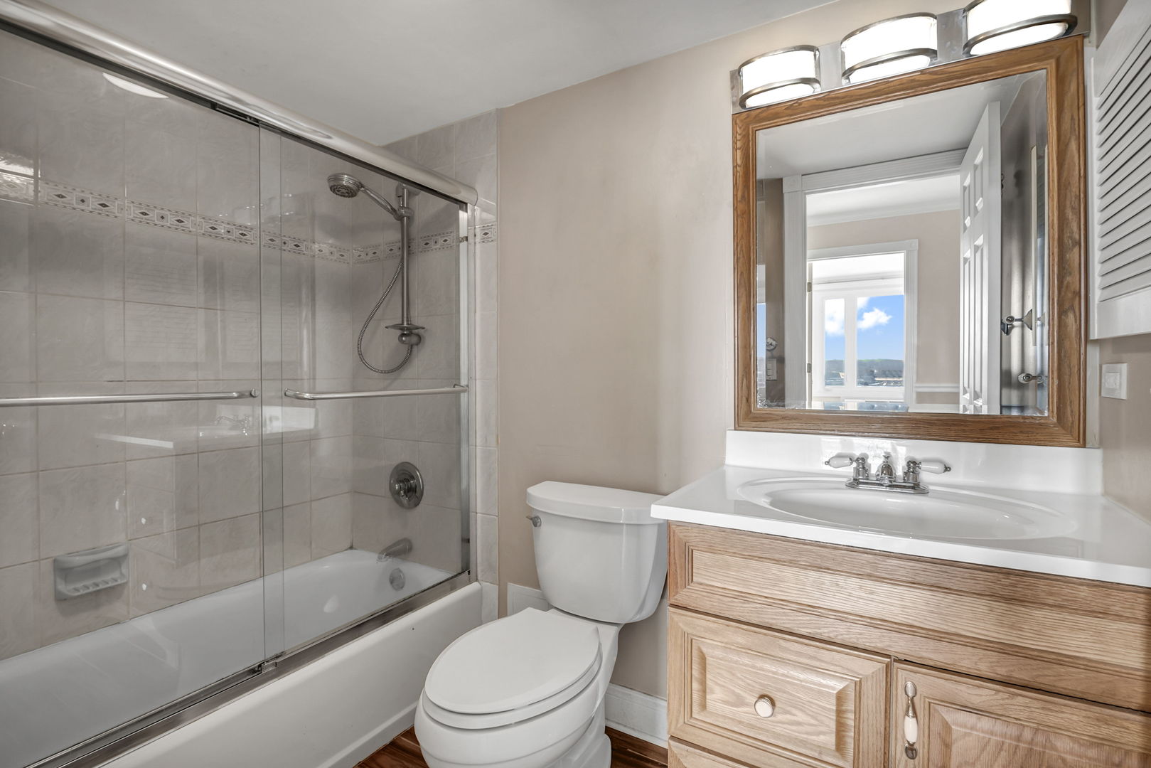 1 Renaissance Place, Unit 911 Palatine, IL 60067 - Photo 9 of 17 a bathroom with a sink a toilet and a mirror