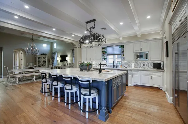 a kitchen with lots of counter top space and painting on the wall