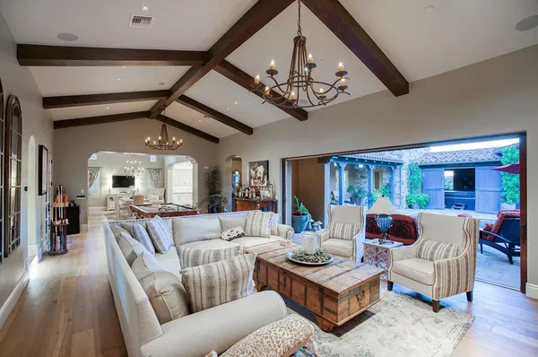 a living room with furniture and a chandelier