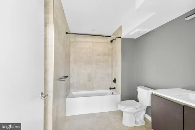 a bathroom with a toilet and a bathtub