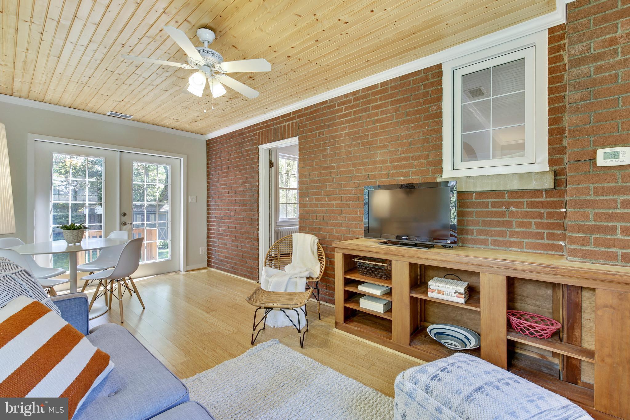 9129 Bradford Road Silver Spring, MD 20901 - Photo 12 of 26 a living room with furniture and a fireplace