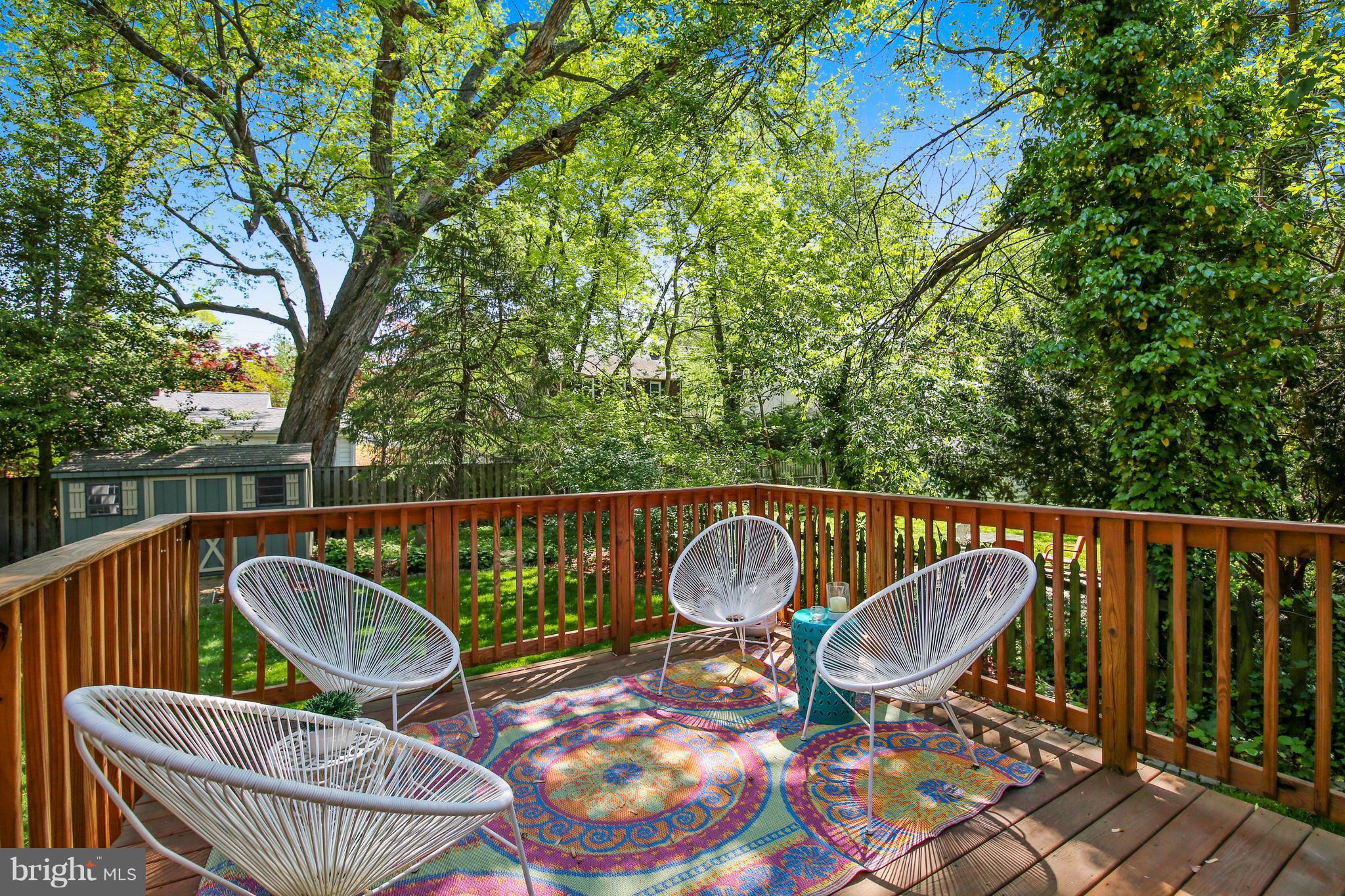 9129 Bradford Road Silver Spring, MD 20901 - Photo 13 of 26 a patio with wooden floor table and chairs