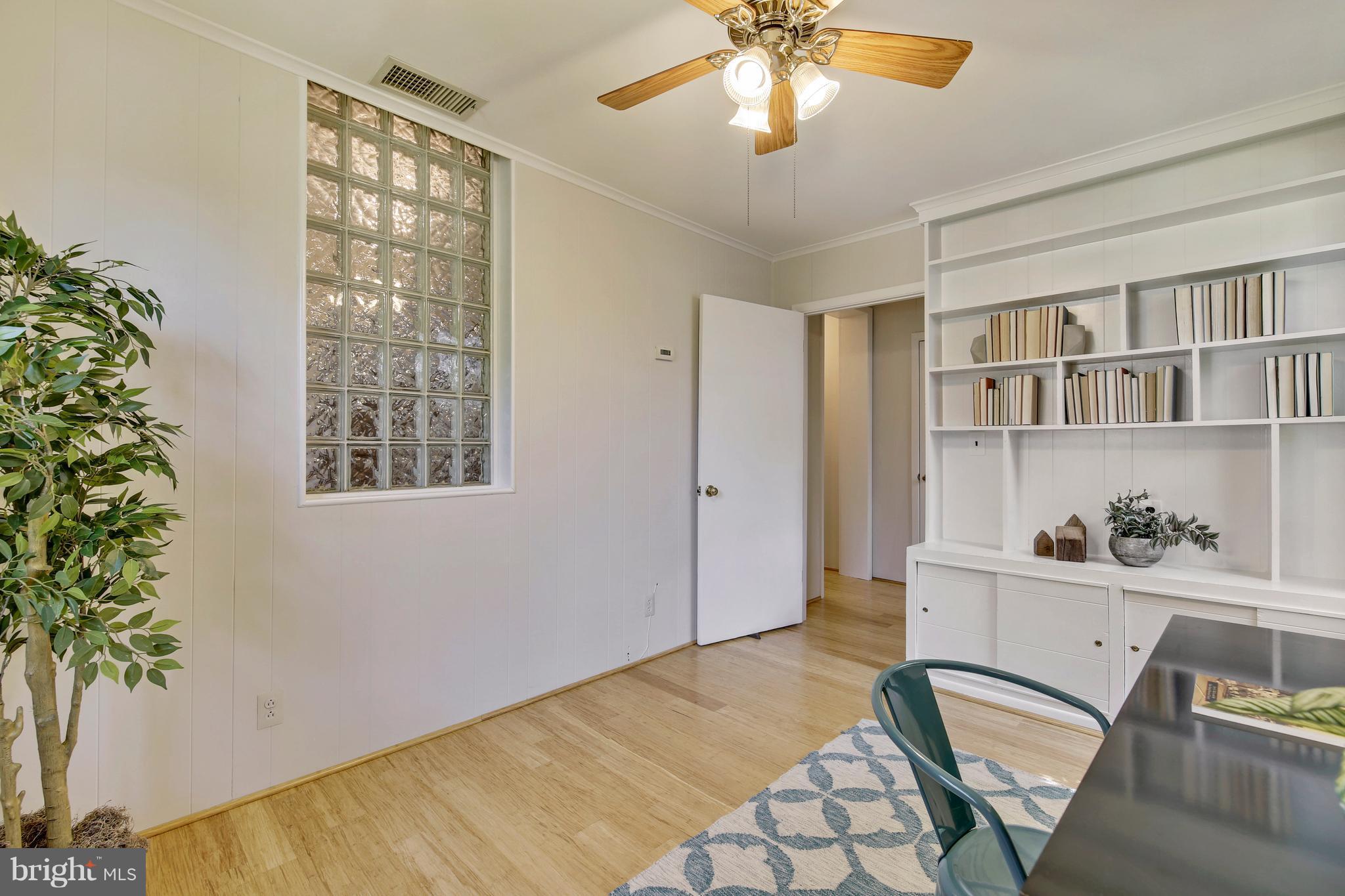 9129 Bradford Road Silver Spring, MD 20901 - Photo 20 of 26 a bedroom with a bed and a potted plant