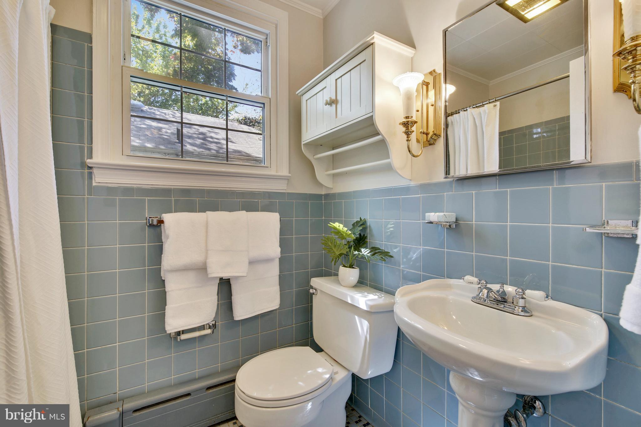 9129 Bradford Road Silver Spring, MD 20901 - Photo 21 of 26 a bathroom with a sink toilet and mirror