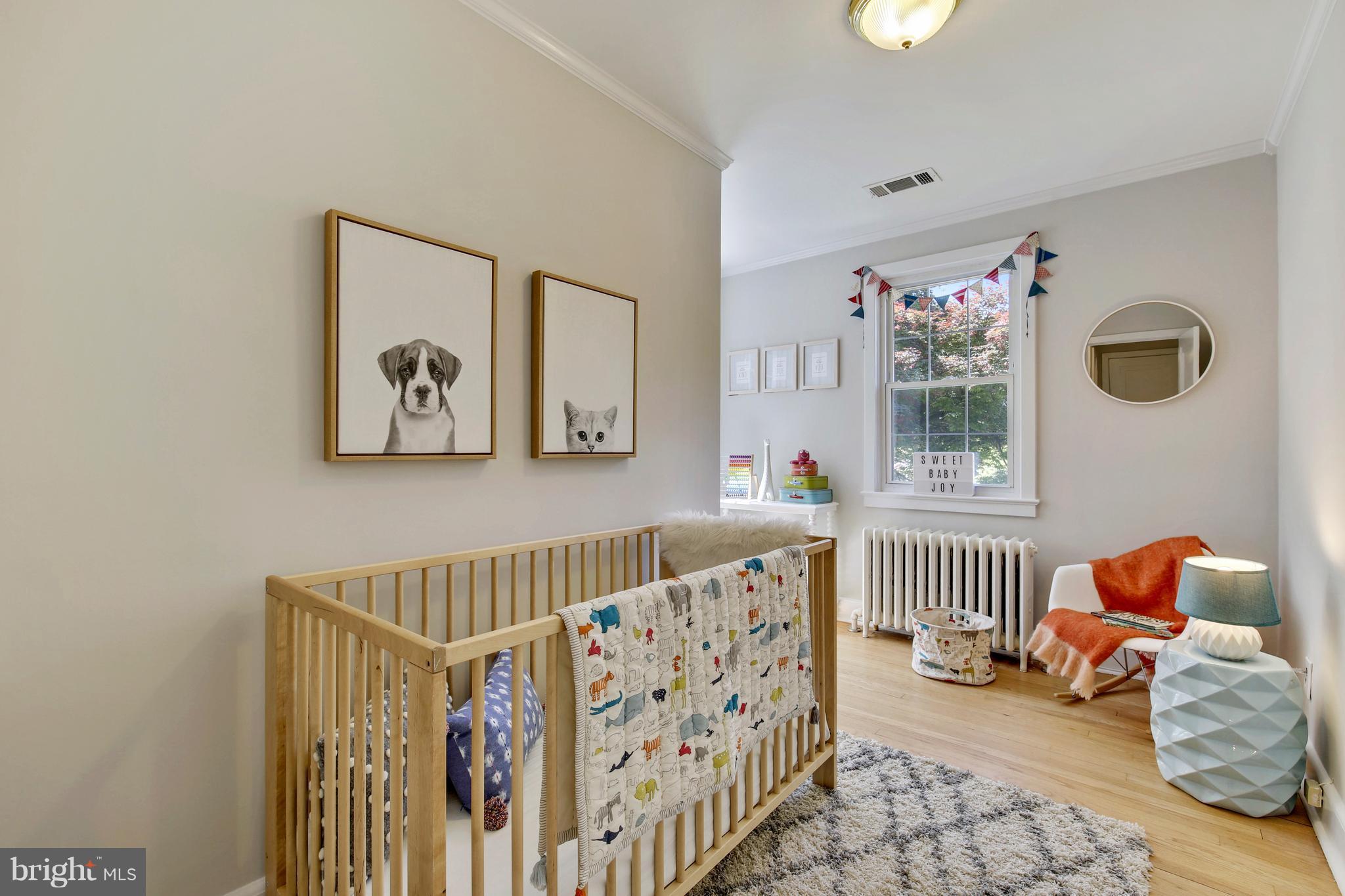 9129 Bradford Road Silver Spring, MD 20901 - Photo 22 of 26 a bedroom with furniture and baby crib