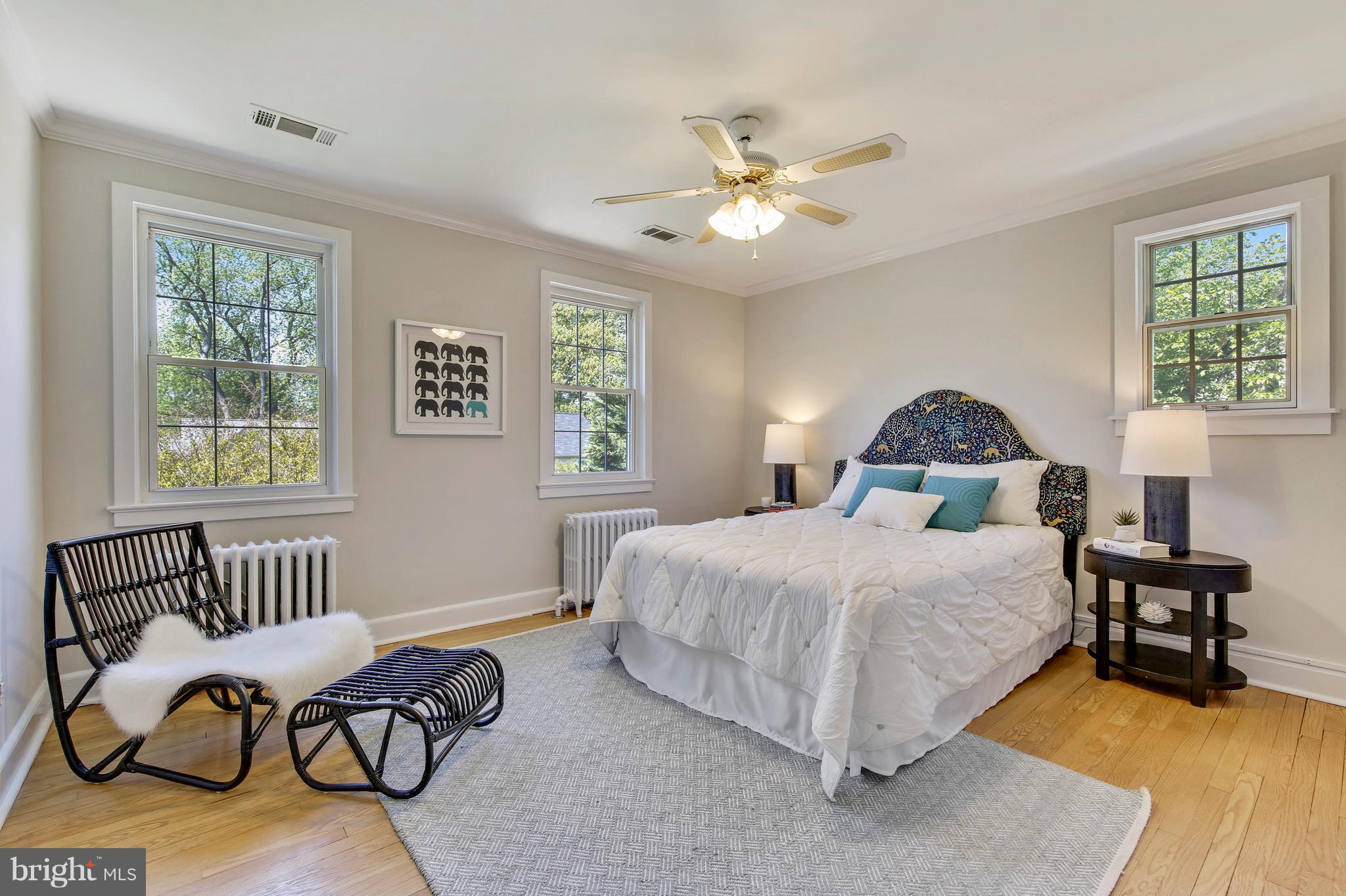 9129 Bradford Road Silver Spring, MD 20901 - Photo 25 of 26 a bedroom with a bed and wooden floor