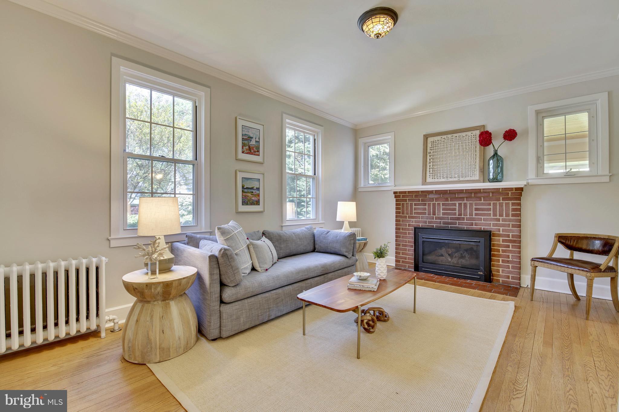9129 Bradford Road Silver Spring, MD 20901 - Photo 4 of 26 a living room with furniture and a fireplace
