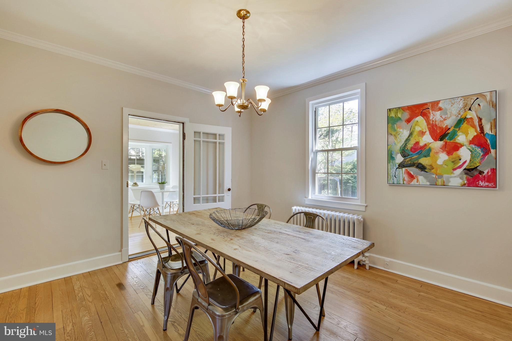 9129 Bradford Road Silver Spring, MD 20901 - Photo 6 of 26 a view of a dining room with furniture wooden floor and a chandelier