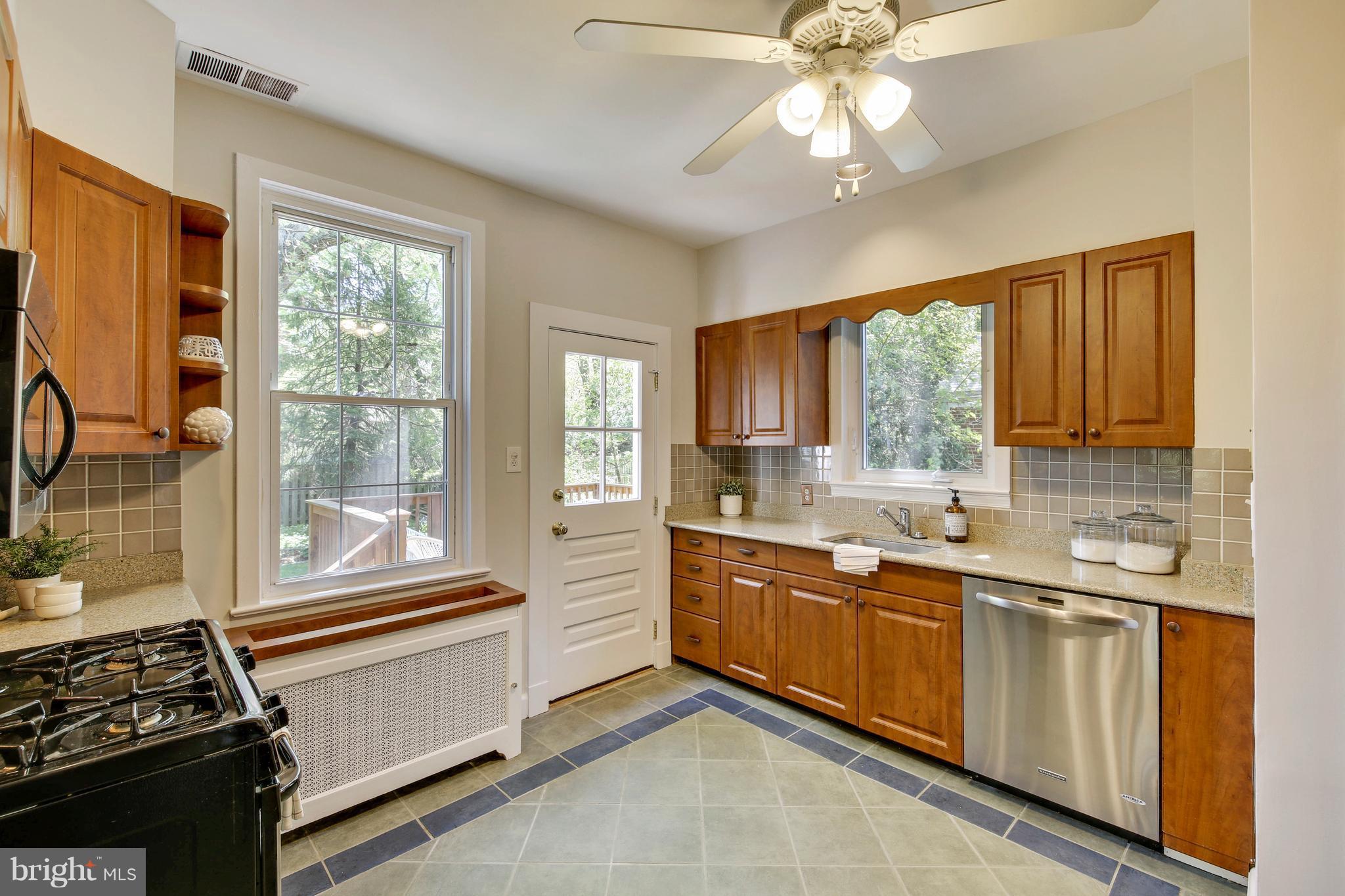 9129 Bradford Road Silver Spring, MD 20901 - Photo 8 of 26 a kitchen with a window a sink and cabinets