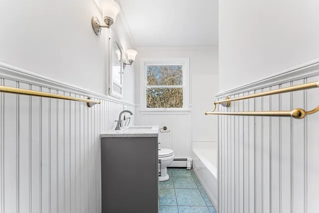 a bathroom with a sink a toilet and mirror