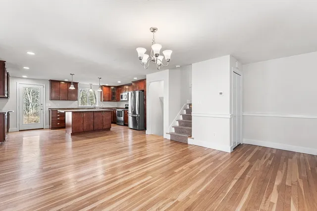 a view of a kitchen with wooden floor and a kitchen