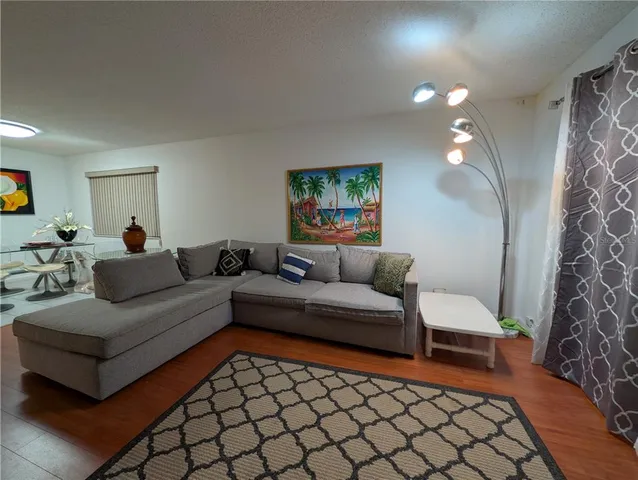 a living room with furniture and a rug