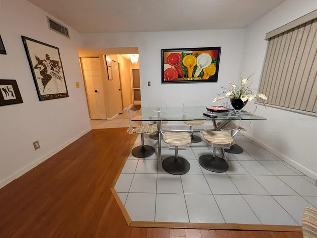 a living room with furniture a flat screen tv and a table