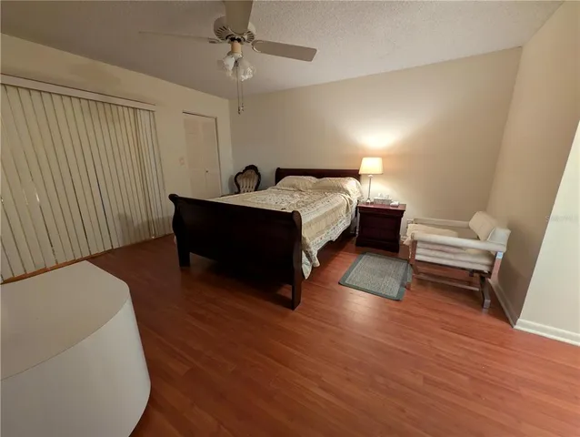 a spacious bedroom with a bed and a couch