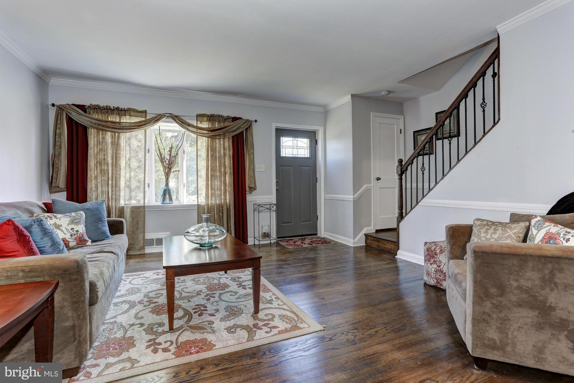 5922 Hillen Road Baltimore, MD 21239 - Photo 2 of 24 a living room with furniture and a rug