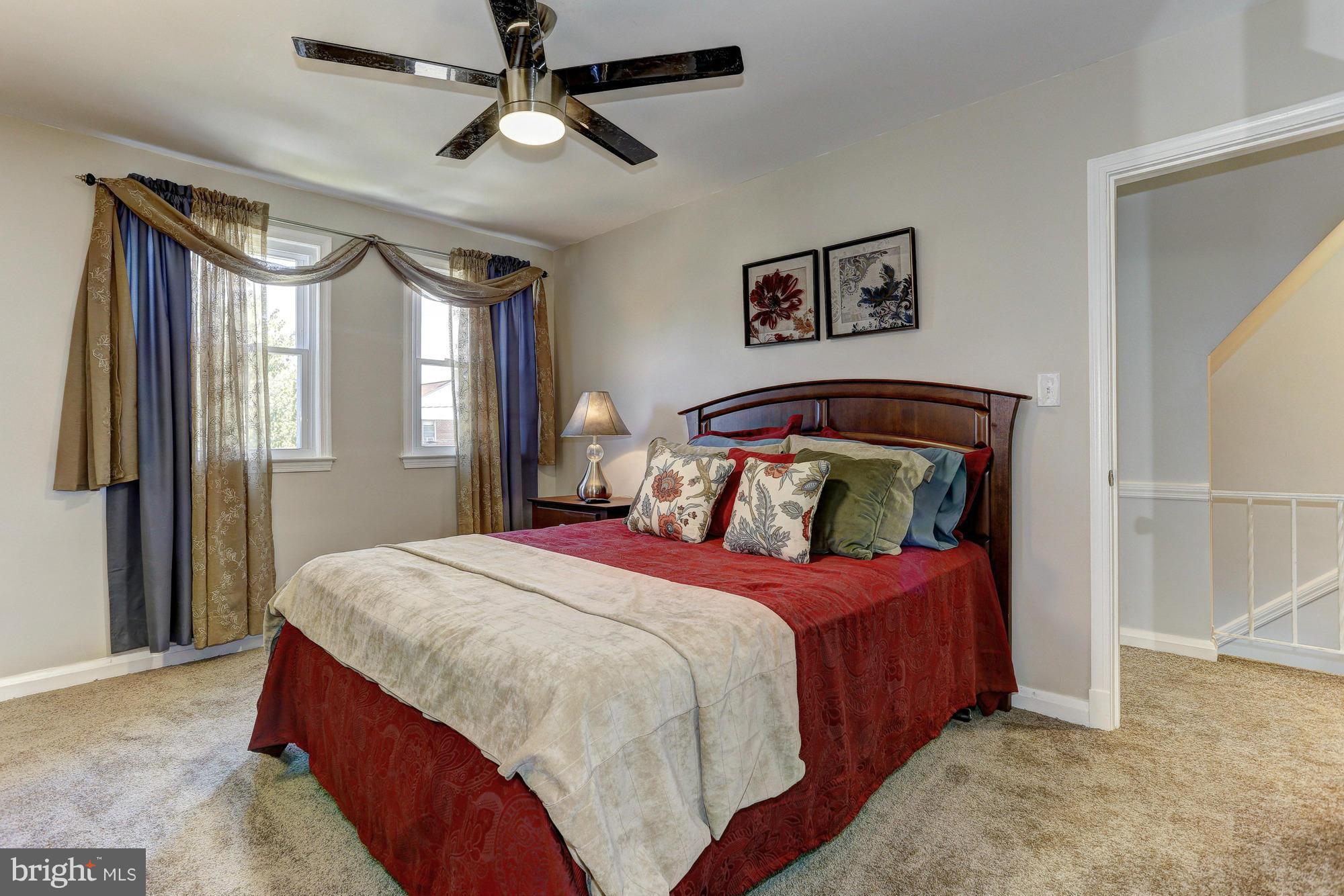 5922 Hillen Road Baltimore, MD 21239 - Photo 13 of 24 a bedroom with a bed and a large mirror
