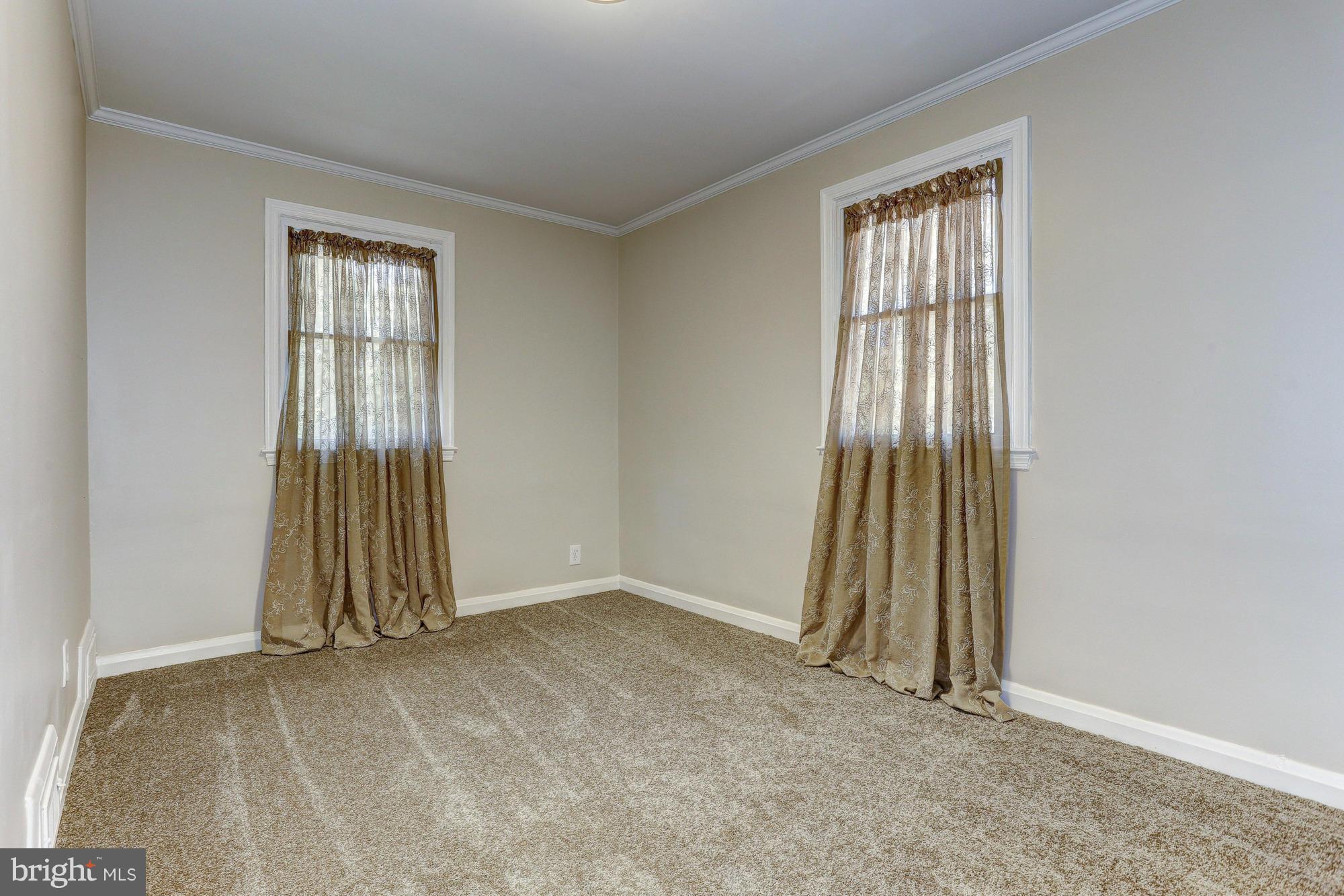 5922 Hillen Road Baltimore, MD 21239 - Photo 14 of 24 an empty room with a window