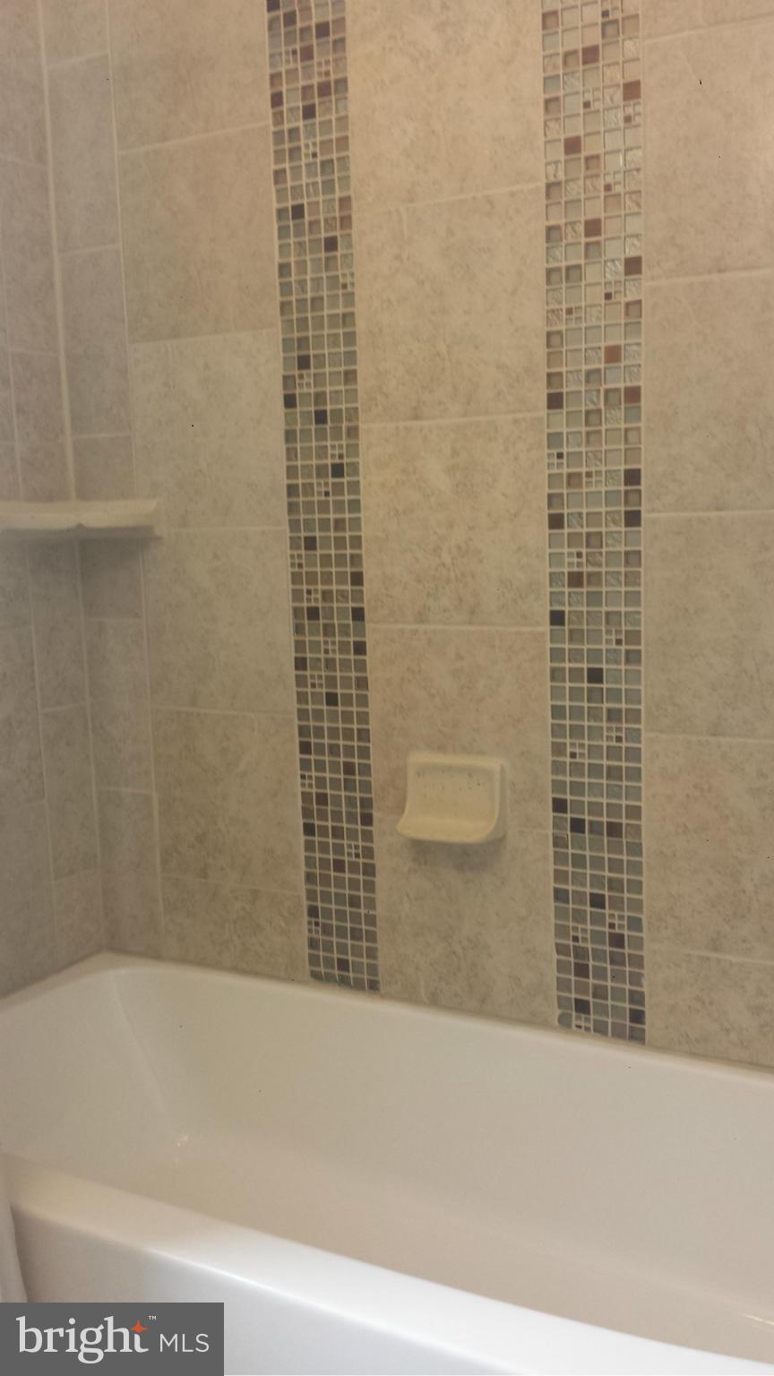 5922 Hillen Road Baltimore, MD 21239 - Photo 16 of 24 a bathroom with a bathtub and shower