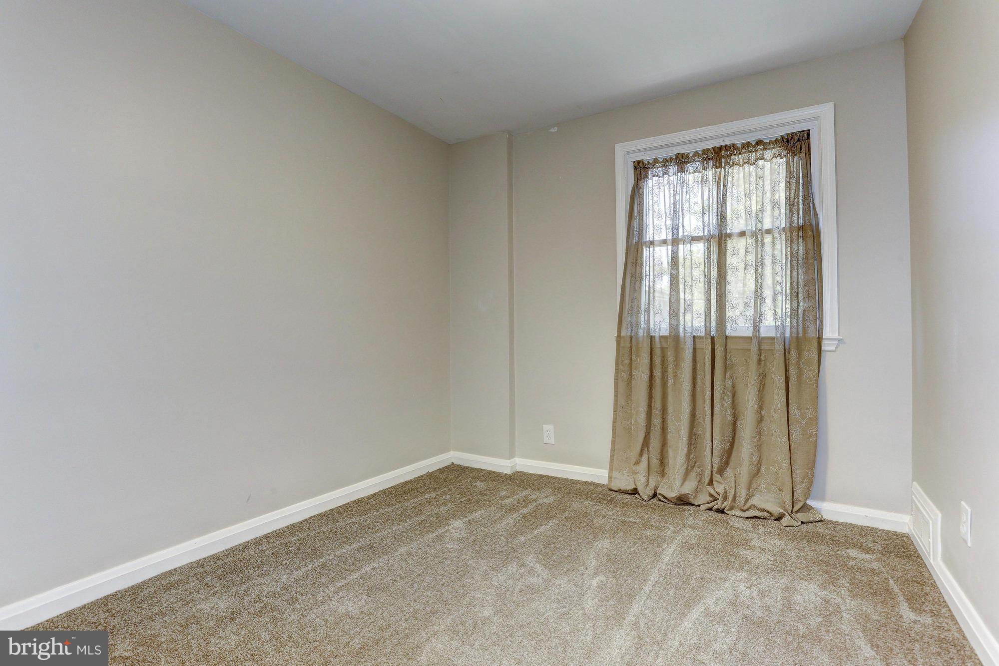 5922 Hillen Road Baltimore, MD 21239 - Photo 18 of 24 an empty room with window