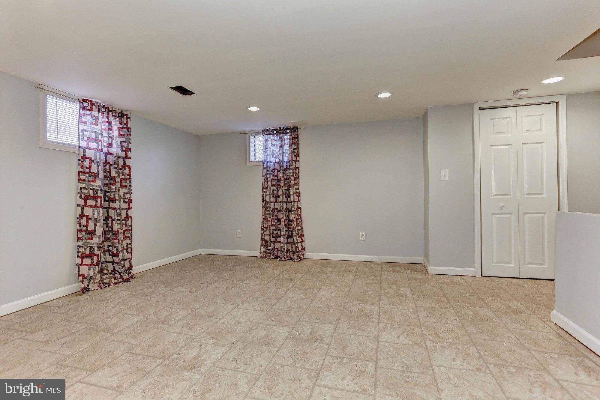 5922 Hillen Road Baltimore, MD 21239 - Photo 20 of 24 a view of an empty room with a cabinet and mirrors