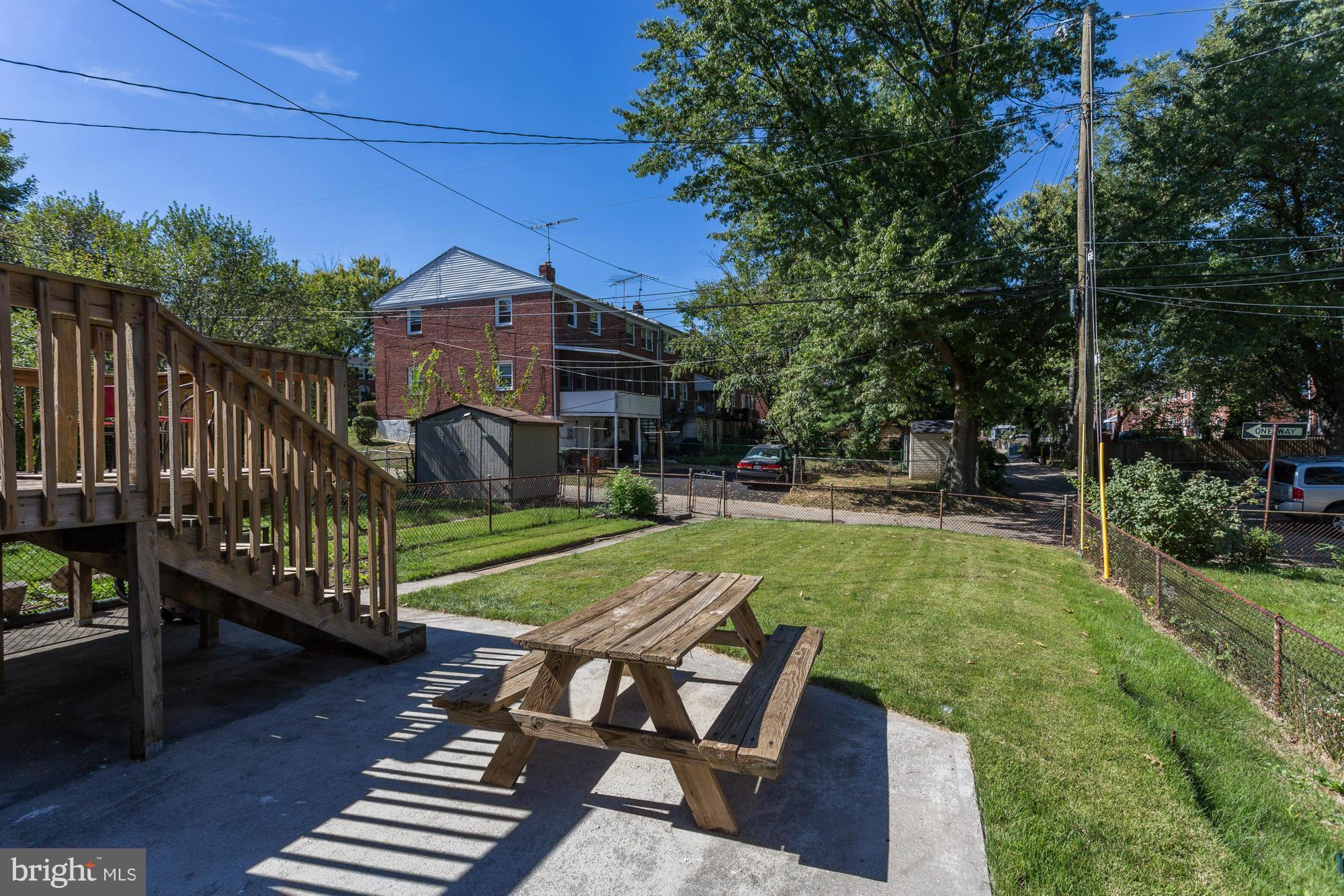 5922 Hillen Road Baltimore, MD 21239 - Photo 22 of 24 a view of a wooden deck and a yard