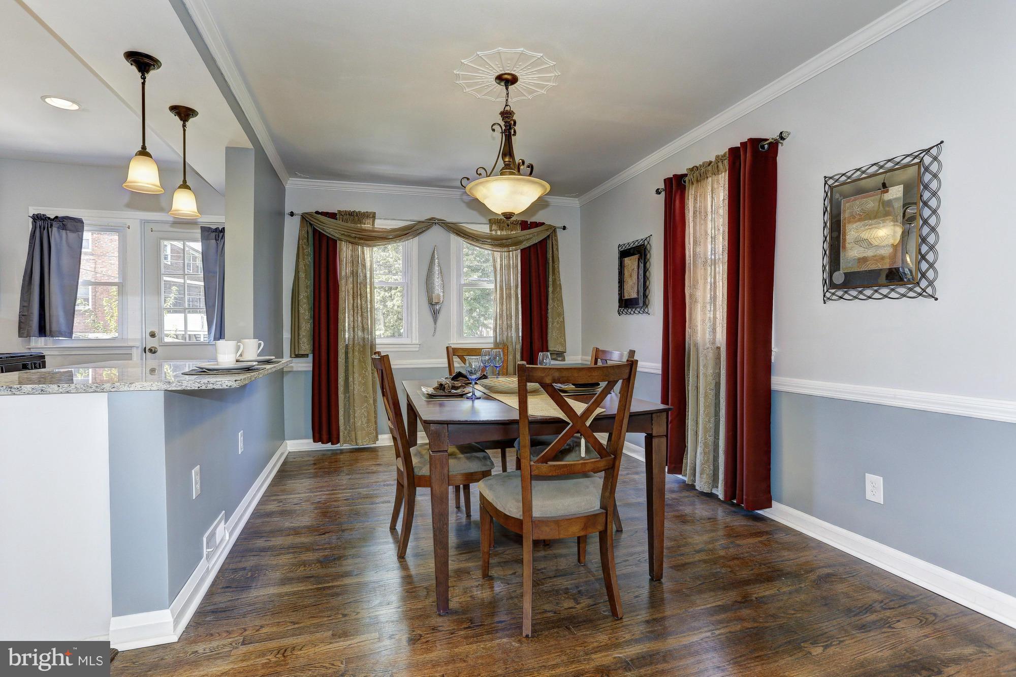 5922 Hillen Road Baltimore, MD 21239 - Photo 5 of 24 a view of a dining room with furniture window and wooden floor