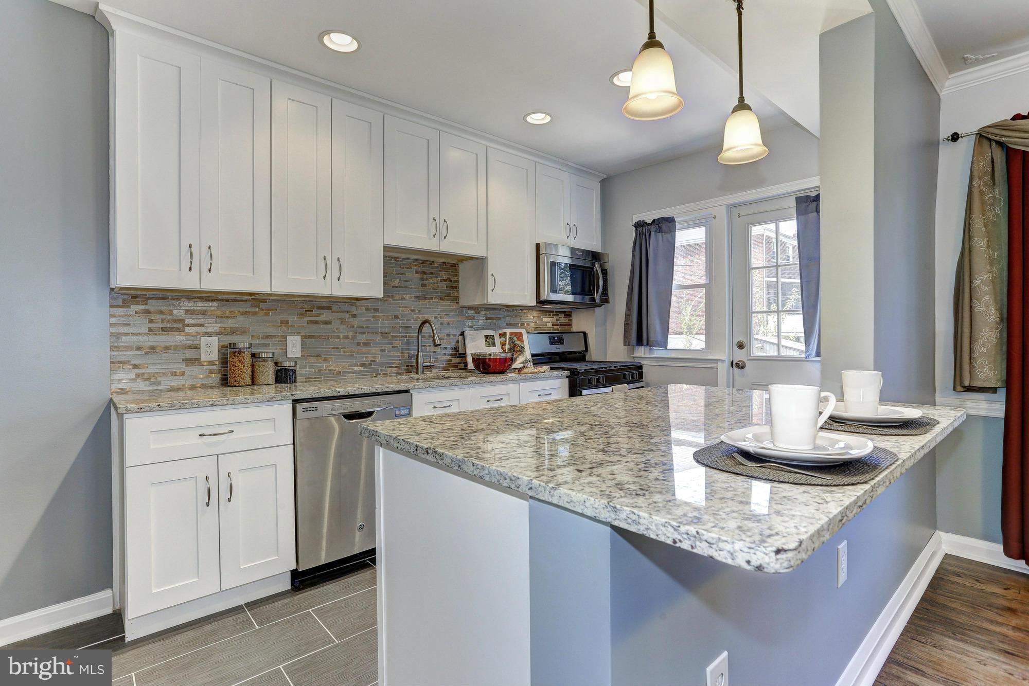 5922 Hillen Road Baltimore, MD 21239 - Photo 8 of 24 a kitchen with granite countertop a sink a counter top space appliances and cabinets