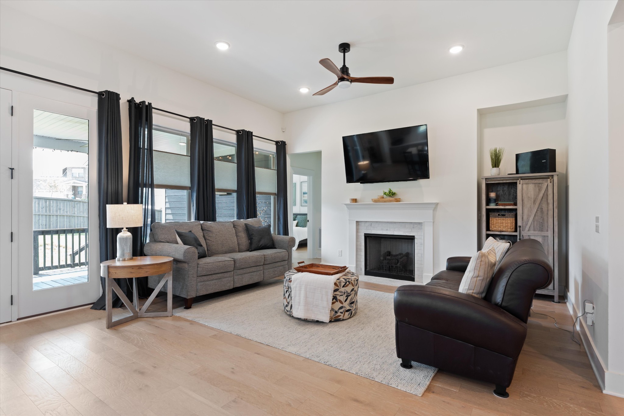 4051 John Marsh Road Spring Hill, TN 37174 - Photo 13 of 46 a living room with furniture a flat screen tv and a fireplace