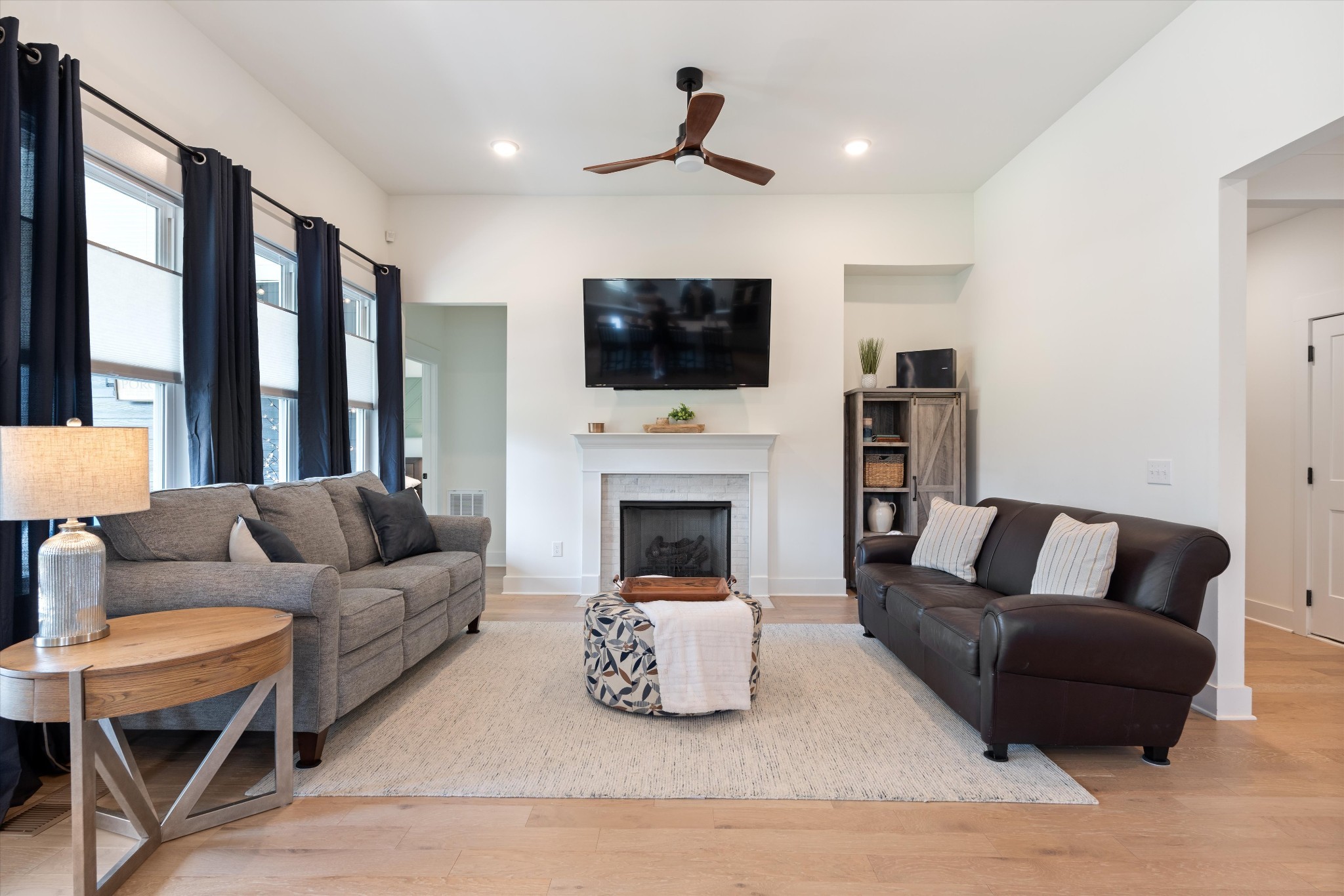 4051 John Marsh Road Spring Hill, TN 37174 - Photo 14 of 46 a living room with furniture a flat screen tv and a fireplace
