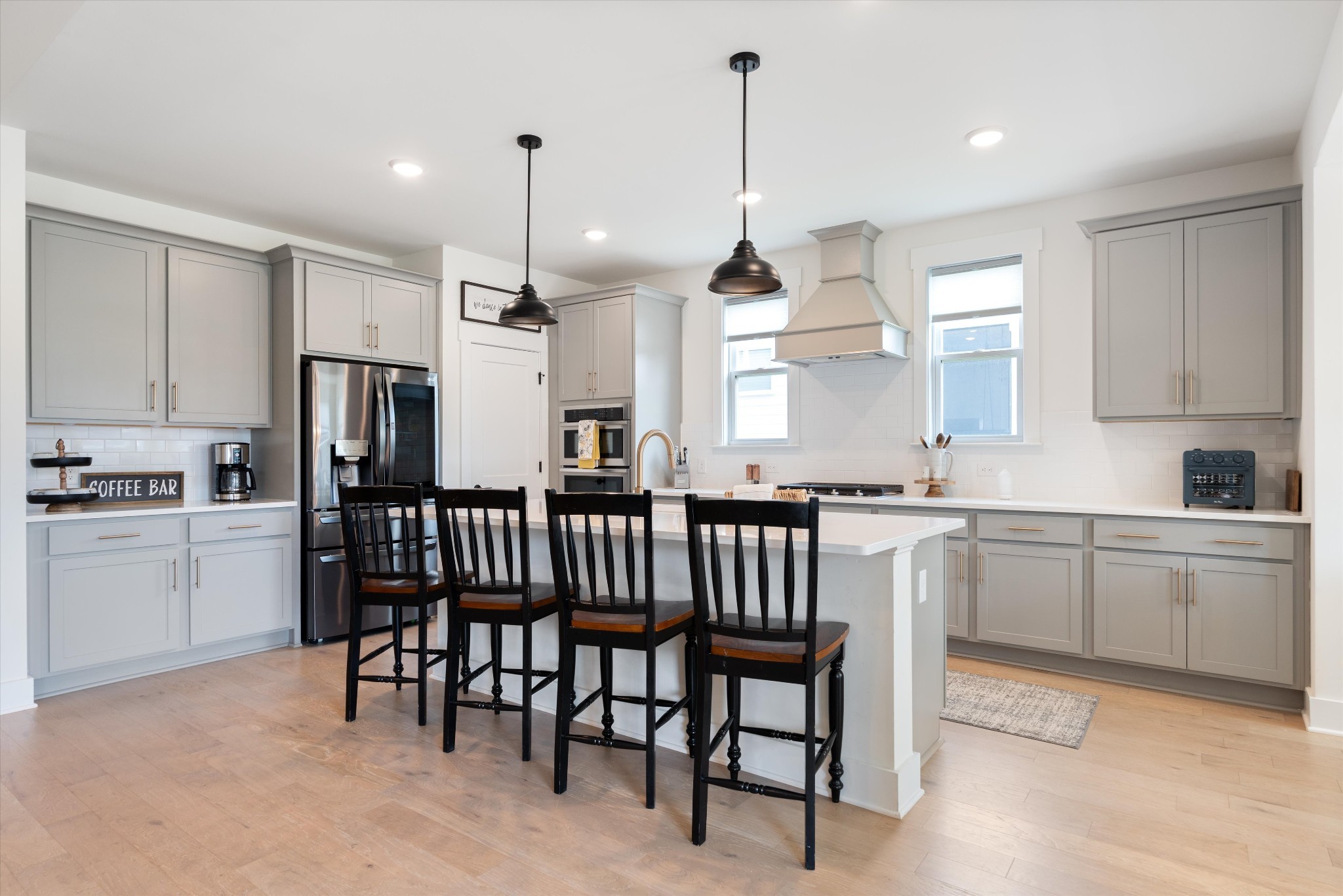 4051 John Marsh Road Spring Hill, TN 37174 - Photo 15 of 46 a kitchen with stainless steel appliances kitchen island granite countertop a table chairs sink and cabinets
