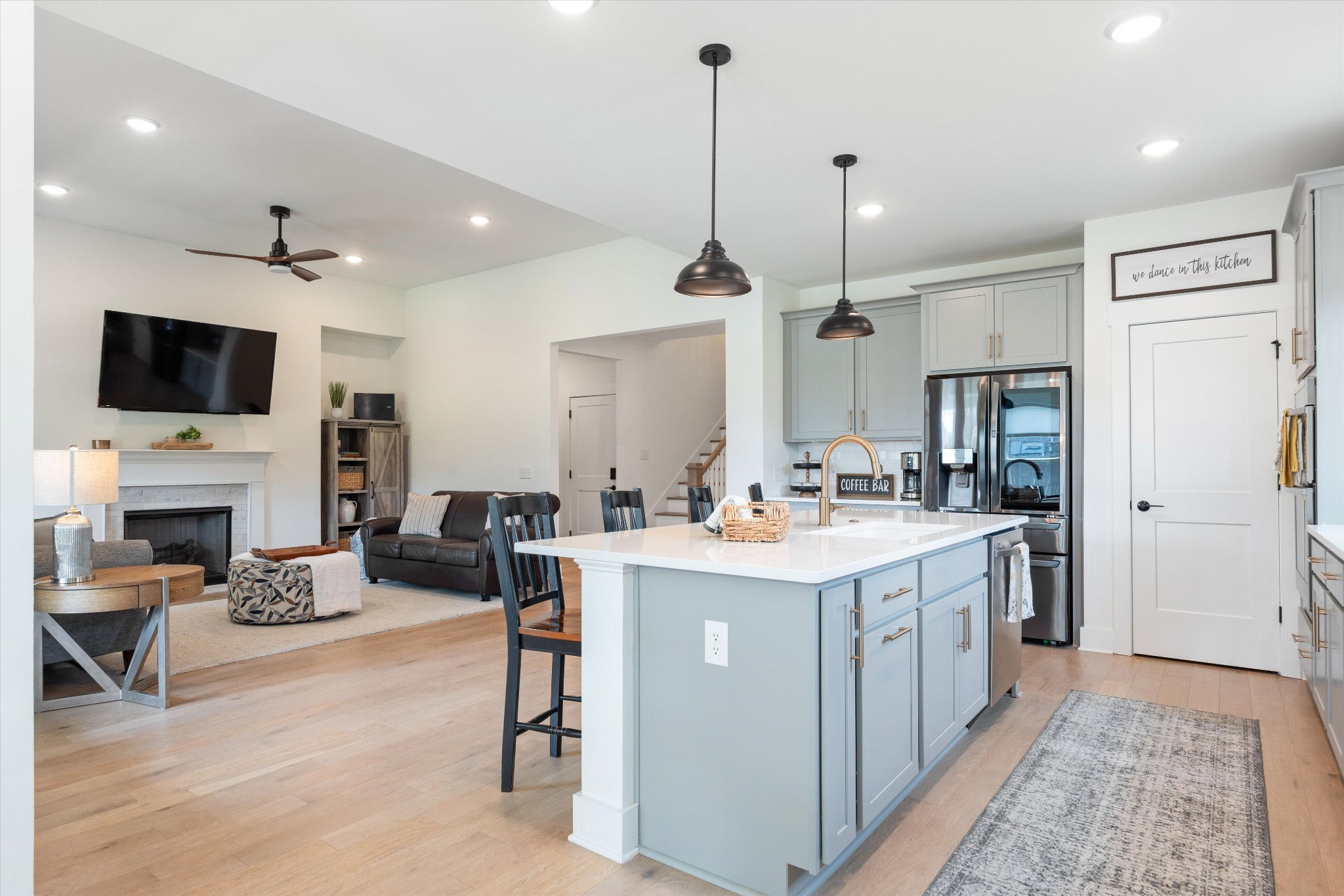 4051 John Marsh Road Spring Hill, TN 37174 - Photo 17 of 46 a view of kitchen with kitchen island stainless steel appliances sink stove and living room view