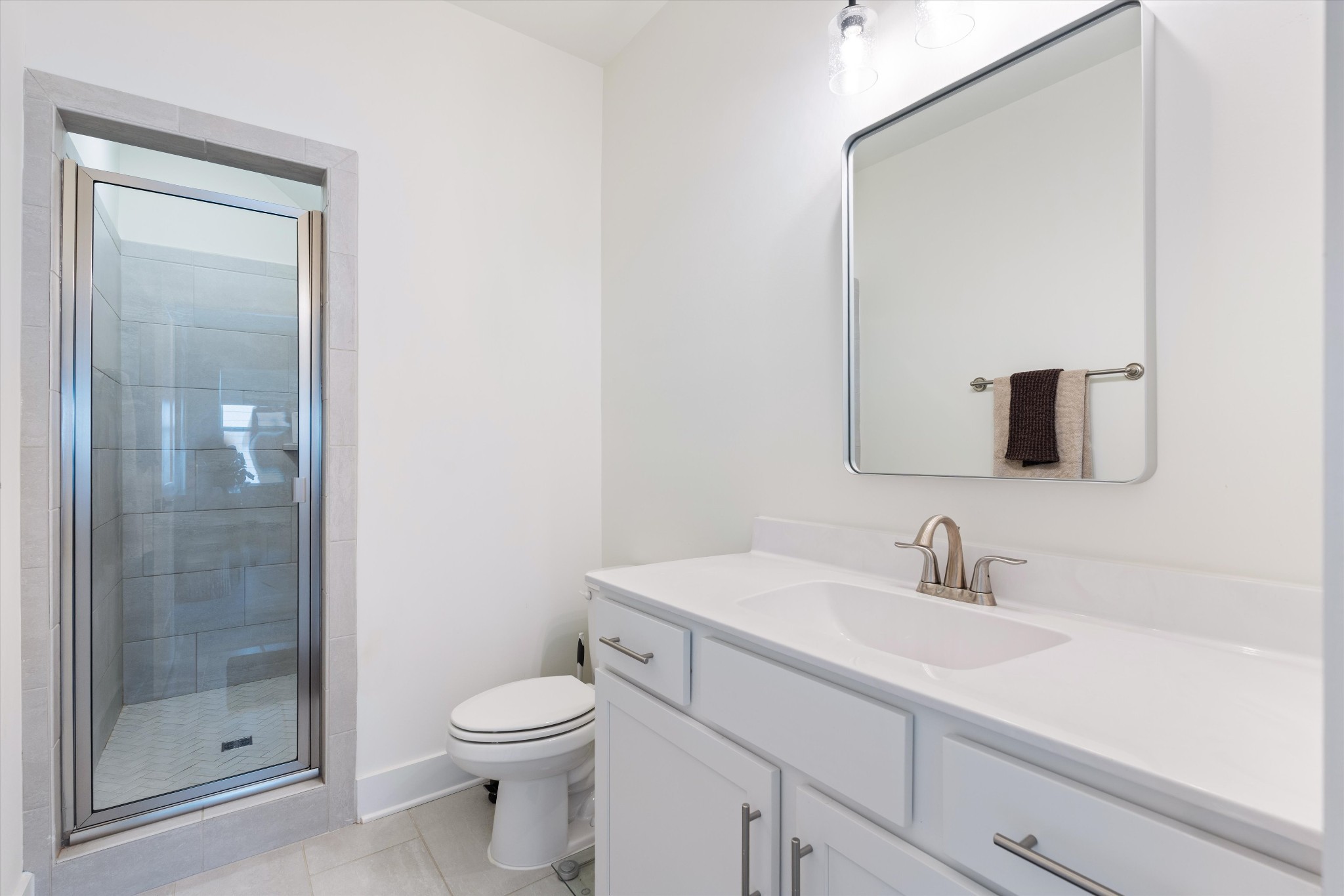 4051 John Marsh Road Spring Hill, TN 37174 - Photo 35 of 46 a bathroom with a sink a toilet and shower