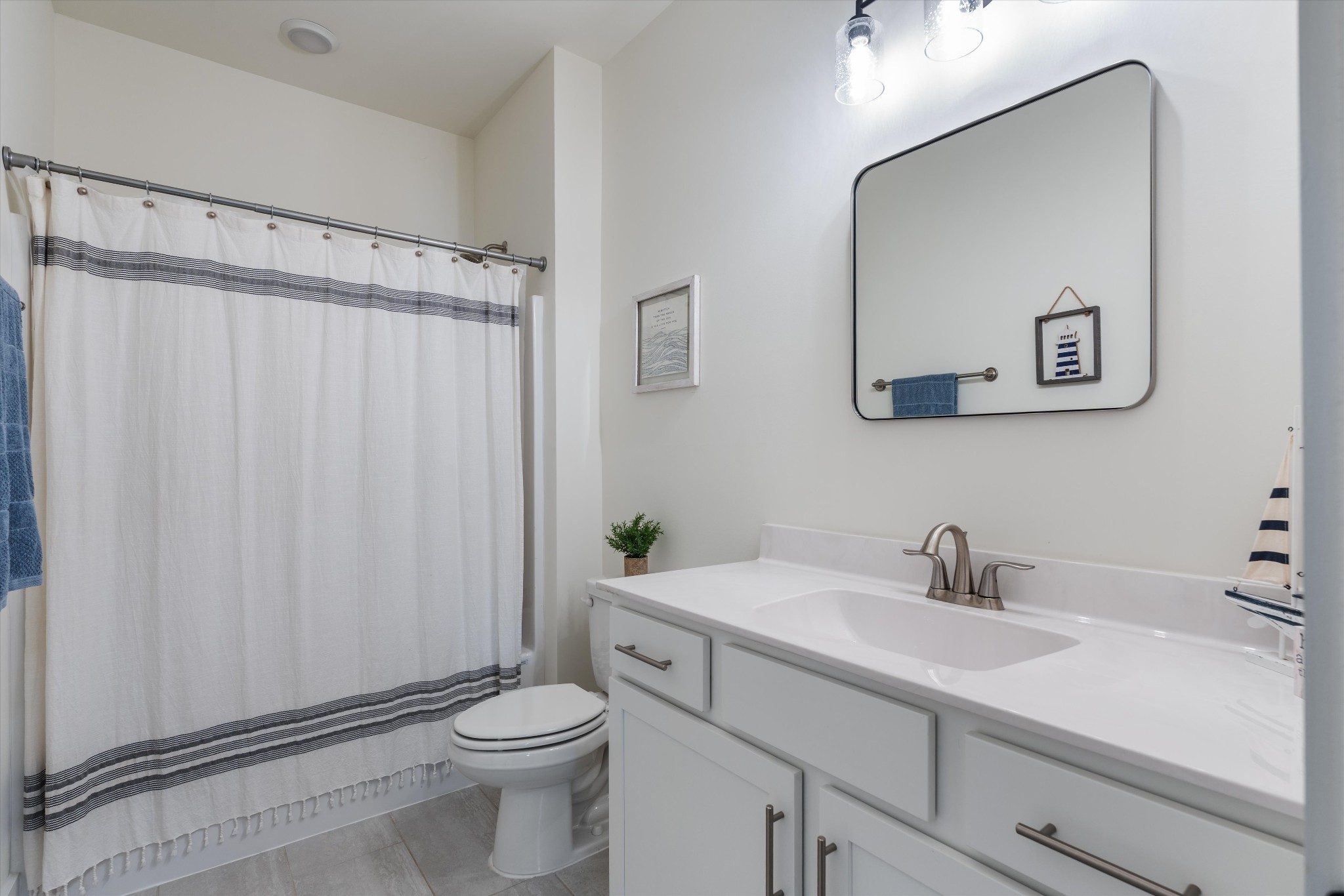4051 John Marsh Road Spring Hill, TN 37174 - Photo 37 of 46 a bathroom with a sink a toilet and a mirror