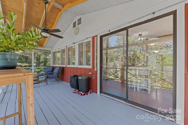 a view of a porch with furniture and wooden floor
