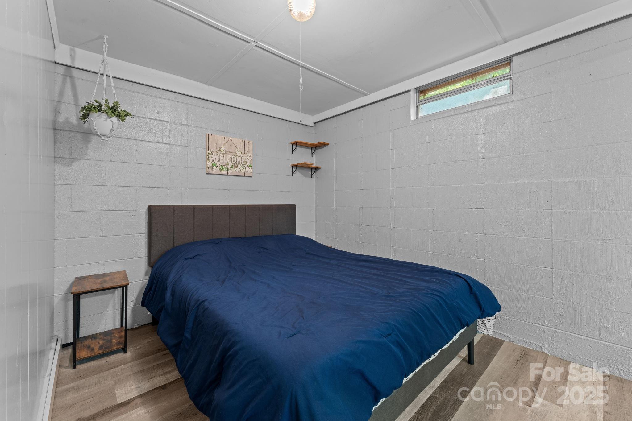 30 Maxies Corner Road Franklin, NC 28734 - Photo 23 of 33 a bedroom with a bed and a table in it