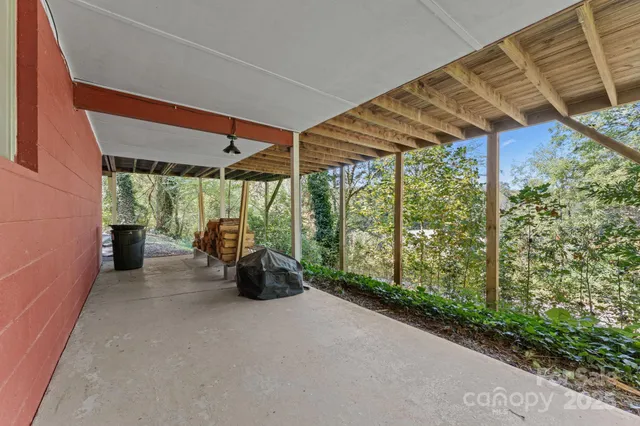 a view of a porch with furniture and garden
