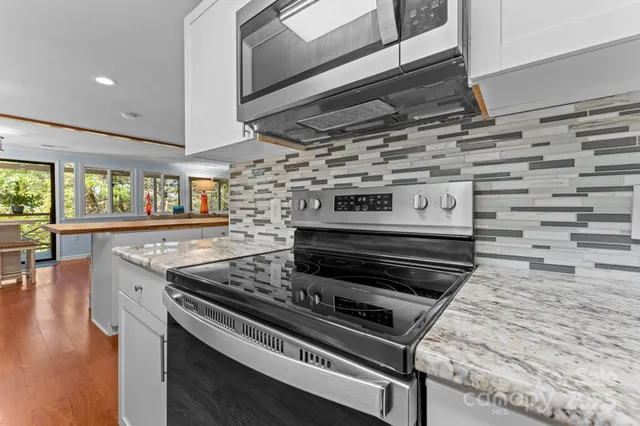 a stove top oven sitting inside of a kitchen