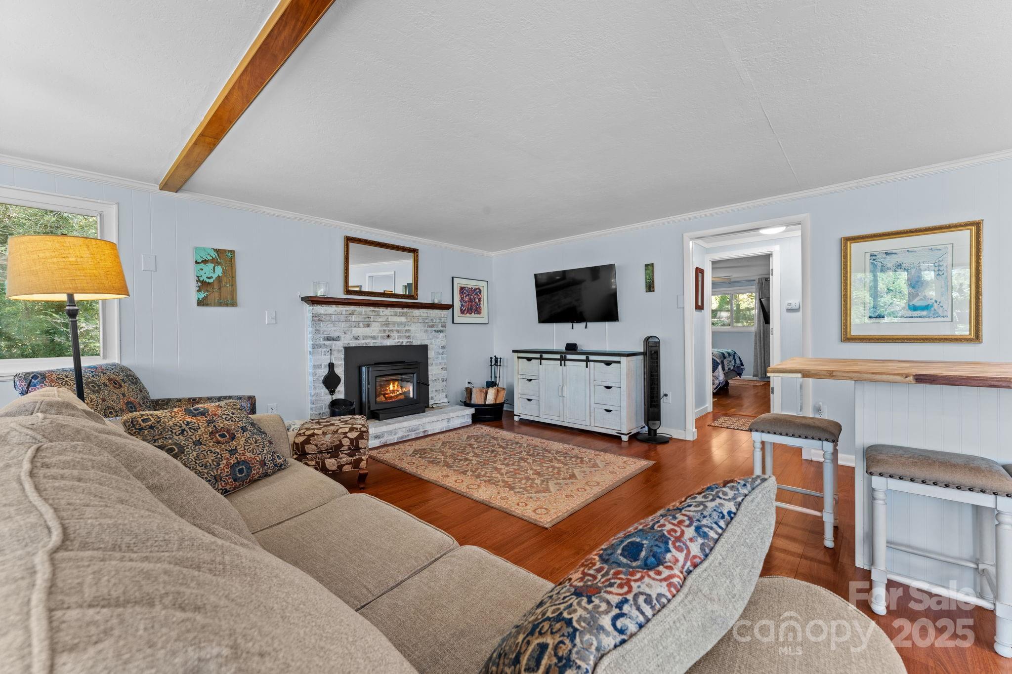 30 Maxies Corner Road Franklin, NC 28734 - Photo 10 of 33 a living room with furniture a fireplace and a flat screen tv