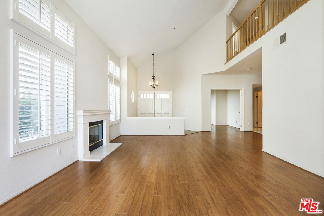 889 C. Amable Glendale, CA 91208 - Photo 11 of 51 a view of an empty room with wooden floor and a window